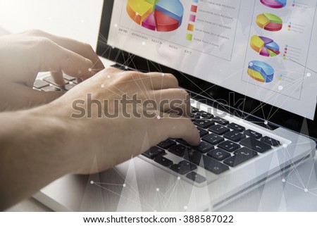 technology and business concept: man using a laptop with financial software on the screen