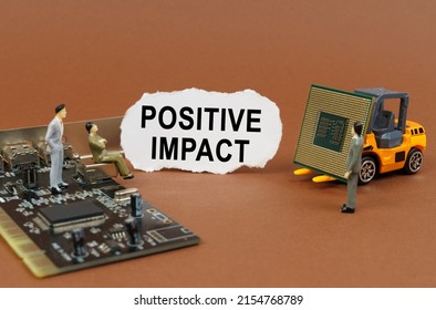 Technology And Business Concept. On A Brown Surface, A Loader With A Processor, A Microcircuit, Figures Of People And Torn Paper With The Inscription - Positive Impact