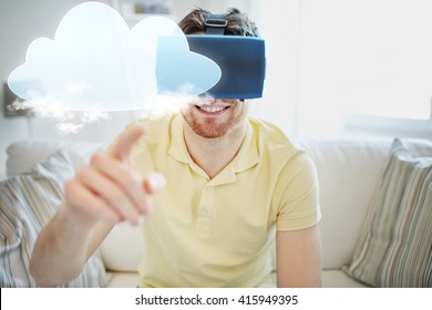 technology, cloud computing, gaming, entertainment and people concept - happy young man in virtual reality headset or 3d glasses with cloud projection at home
