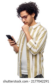 technology, communication and people concept - puzzled young man with smartphone over white background