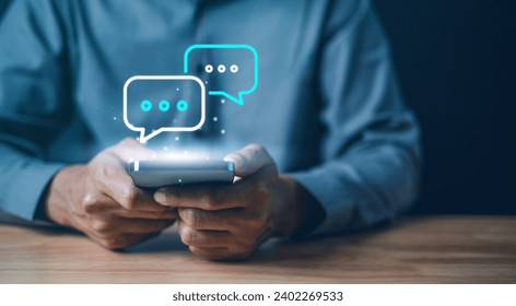 Technology, communication, Social media text messaging concepts, Businessman using smartphone texting message while sitting on table with in work office.	