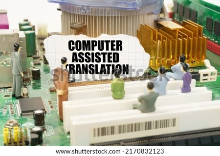 Technology and computer concept. On the motherboard there are figures of people and torn paper with the inscription - Computer Assisted Translation