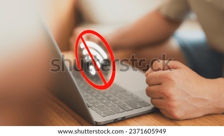 Technology concept of wifi connected but no internet. Man using a laptop computer to connect to wifi but wifi not connected or password is incorrect and waiting to loading digital data form website.