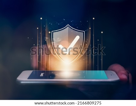 Technology cyber security internet and networking online concept, hand touching interface verified and icon shield on smartphone.