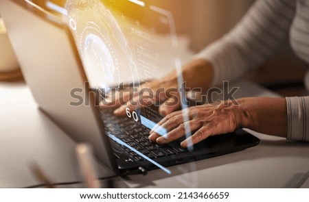 technology, cyberspace and programming concept - close up of senior woman hands typing on laptop at home and virtual hologram with data