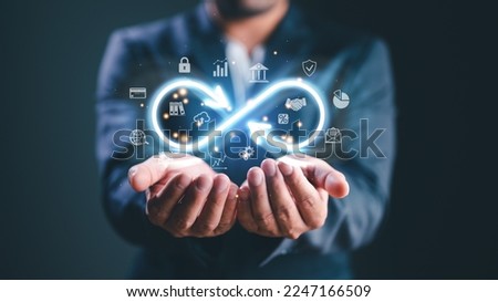 Technology data link concept, Businessman Hands holding virtual infinity with technology marketing online icon for symbol of connection to community metaverse world network system concept.