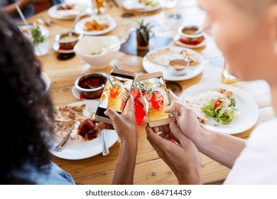 technology, eating and people concept - couple with smartphones photographing cocktail drinks in mason jar glasses at restaurant - Powered by Shutterstock