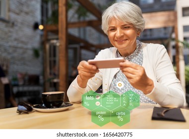 Technology, Eating And People Concept - Happy Senior Woman With Smartphone And Cup Of Coffee At Street Cafe Over Food Nutritional Value Chart