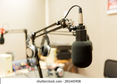 technology, electronics and audio equipment concept - close up of microphone at recording studio or radio station