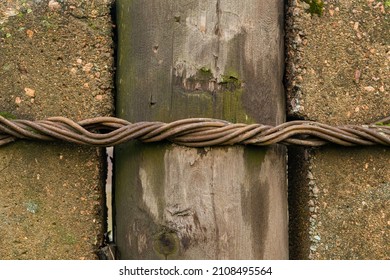 The Technology Of Fastening A Wooden Electric Pole To Reinforced Concrete Piles. Background Picture. Twisted Metal Wire.