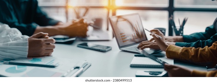 Technology and financial advisory services concept. Business teamwork and working on digital laptop computer with advisor showing plan of investment to clients at table office. Digital marketing. - Powered by Shutterstock