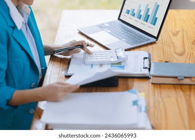 Technology and financial analytics data advisory concept. Businesswoman working on digital laptop computer with advisor showing plan of investment to clients at table office. Digital marketing.