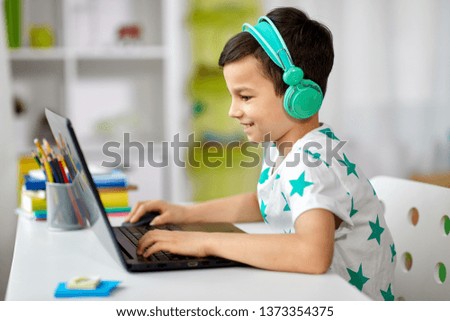 Similar – Happy child with laptop computer on brick background