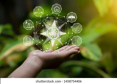 Technology, hand holding with environment Icons over the Network connection on green background. - Shutterstock ID 1458754406