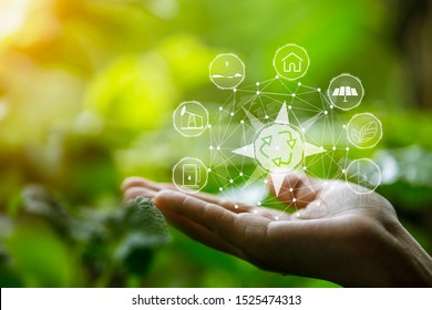 Technology, hand holding with environment Icons over the Network connection on green background.  - Shutterstock ID 1525474313
