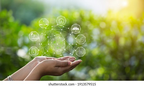 Technology, hand holding with environment Icons over the Network connection on green background. - Shutterstock ID 1913579515