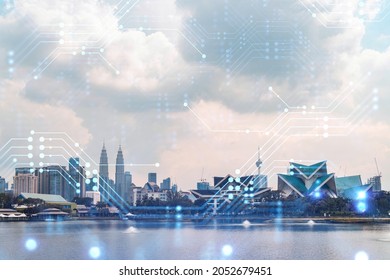 Technology hologram over panorama city view of Kuala Lumpur. KL is the largest tech hub in Malaysia, Asia. The concept of developing coding and high-tech science. Double exposure.