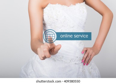 technology, internet and networking concept. Beautiful bride in fashion wedding dress. Bride presses online service button on virtual screens