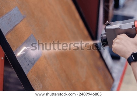 Technology machine laser beam for remove rust from metal. Cleaning iron surface before welding.