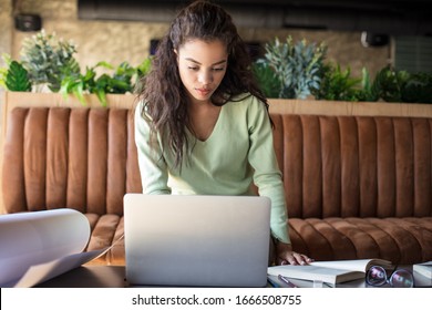 Technology Makes My Life So Much Easier. Young Student Girl In Cafe Working And Using Laptop.