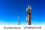 Technology on the top of the telecommunication GSM 4G tower antenna, transmitter , blue sky, white clouds.