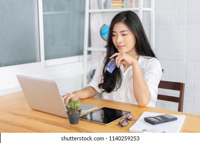 Technology, Online Shopping, Digital Banking, Home Lifestyle Concept, A Beautiful Smiling Asian Woman With A Laptop Computer And Credit Card At Home For Business Payment, Career, E-commerce Trading 