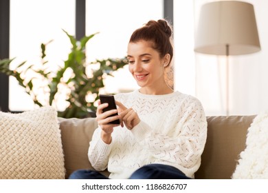 Technology And People Concept - Smiling Woman With Smartphone At Home