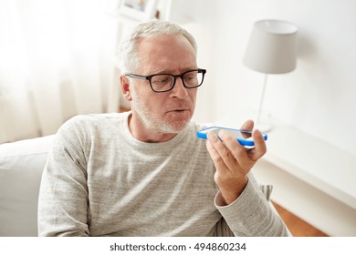 technology, people, lifestyle and communication concept - close up of senior man using voice command recorder or calling on smartphone at home - Powered by Shutterstock