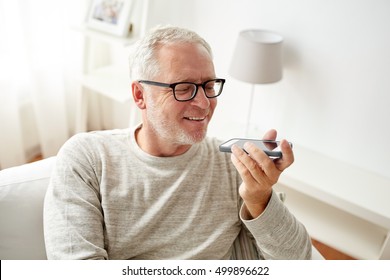 technology, people, lifestyle and communication concept - of happy senior man using voice command recorder or calling on smartphone at home - Powered by Shutterstock