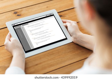 Technology, People And Programming Concept - Close Up Of Woman With Coding Tablet Pc Computer Screen On Wooden Table