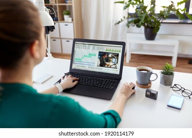 technology, post production and vlog concept - close up of woman working in video editor program on laptop computer working at home office - Shutterstock ID 1920114179