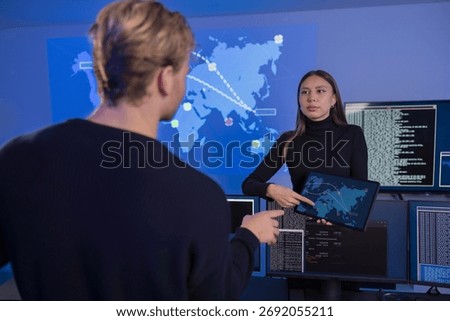 Technology professionals collaboratively analyzing real-time data in a cyber security operations center