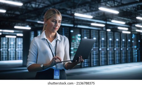 Technology, Progress, Innovation and IT Business Concept. Female European Specialist Using Laptop Computer for High Speed Data and Server Transfer in Big Data Center Office - Powered by Shutterstock - Get 15% off with code: PIKWIZARD15