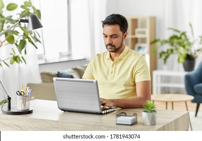 technology, remote job and lifestyle concept - indian man with laptop computer working at home office - Shutterstock ID 1781943074