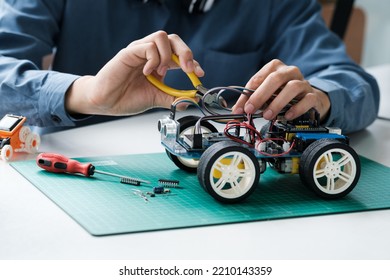 Technology of robotics programing and STEM education concept. Science, Technology, Engineering and Mathematics education. Asian teenager doing robot project in science classroom.  - Powered by Shutterstock