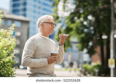 technology, senior people, lifestyle and communication concept - happy old man using voice command recorder or calling on smartphone outdoors - Powered by Shutterstock