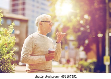 technology, senior people, lifestyle and communication concept - happy old man using voice command recorder or calling on smartphone outdoors - Powered by Shutterstock