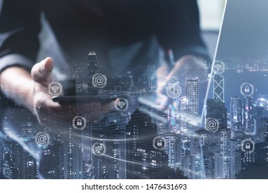 Technology for smart city, IoT Internet of Things, digital data security concept. Double exposure of man using smart phone, electronic devices and cityscape with WiFi icon, internet network connection - Shutterstock ID 1476431693