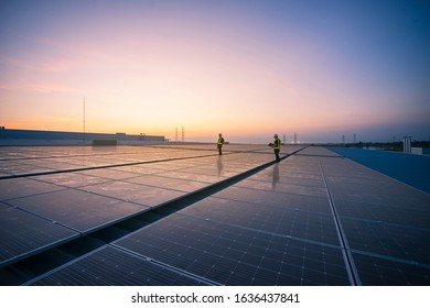 Technology solar cell, Engineer service check installation solar cell on the roof of factory on the morning. Silhouette technician with solar cell on the roof of factory under morning sky. - Shutterstock ID 1636437841