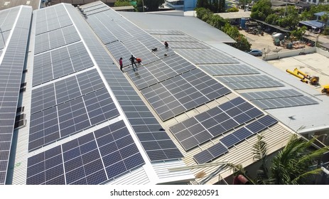 Technology Solar Cell, Engineer Service And Workers Installation Solar Cell On The Roof Of Factory Industry. Technician Inspection And Repair Solar Cell On The Roof Of Factory