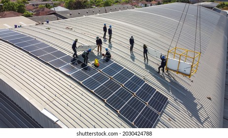 Technology solar cell, Engineer service and workers installation solar cell on the roof of factory industry. technician inspection and repair solar cell on the roof of factory