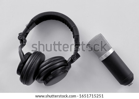 technology, sound recording and audio equipment concept - headphones and microphone on white background
