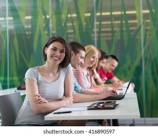 technology students group in computer lab school  classroom working on project and raise hands 