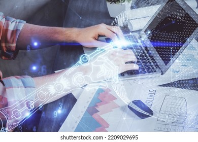 Technology Theme Hologram With Man Working On Computer On Background. High Tech Concept. Multi Exposure.