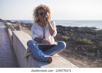 Technology And Travel. Working Outdoors. Freelance Concept. Pretty Young Woman Using Laptop  At The Beach. Vintage Filter And Colors For People At Work In Alternative Office With No Walls. Freedom 