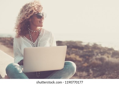 Technology And Travel. Working Outdoors. Freelance Concept. Pretty Young Woman Using Laptop  At The Beach. Vintage Filter And Colors For People At Work In Alternative Office With No Walls. Freedom 