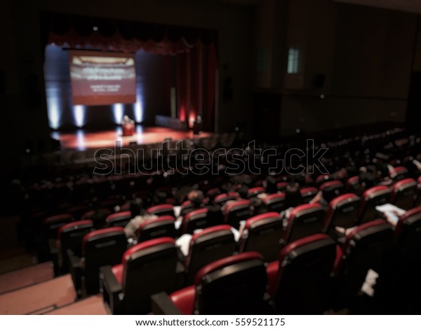 Ted talk international community with audience\
meeting business live in seminar hall blur for background. Ted talk\
show on stage of theatre\
concept.