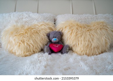 Teddy bear in bedroom representing comfort, bedroom decoration and style, plush toy with plush blanket