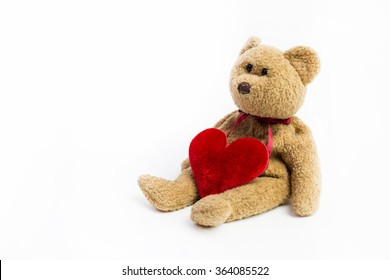 Teddy bear with big red heart isolated over white background