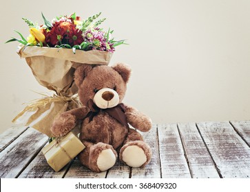 flowers and teddy bear